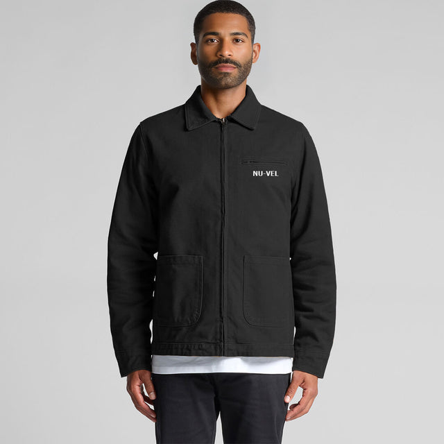 Man wearing a black jacket with 'NU-VEL' logo on a gray background